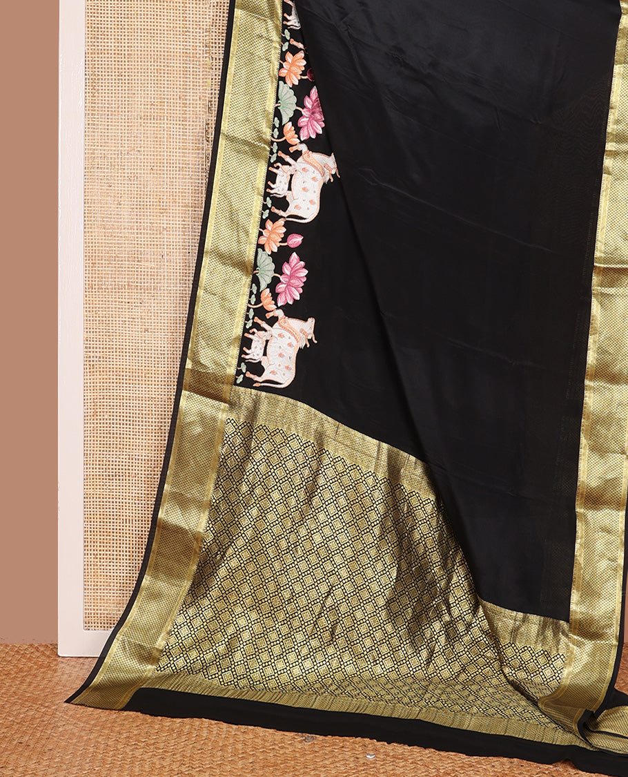 Black delicately thread hand embroidered Mysore silk saree features Pichwai lotus vine, and cow motifs, traditional zari border, and jaal pallu