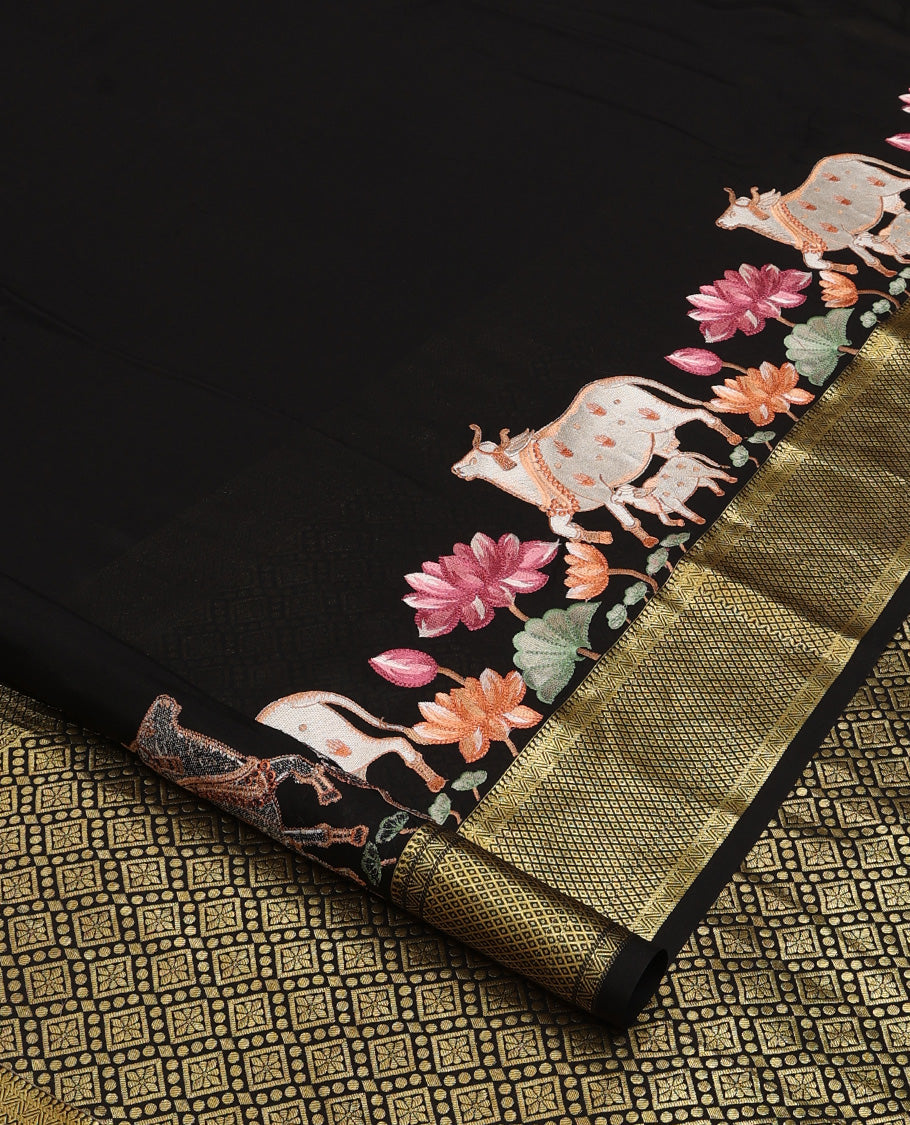 Black delicately thread hand embroidered Mysore silk saree features Pichwai lotus vine, and cow motifs, traditional zari border, and jaal pallu