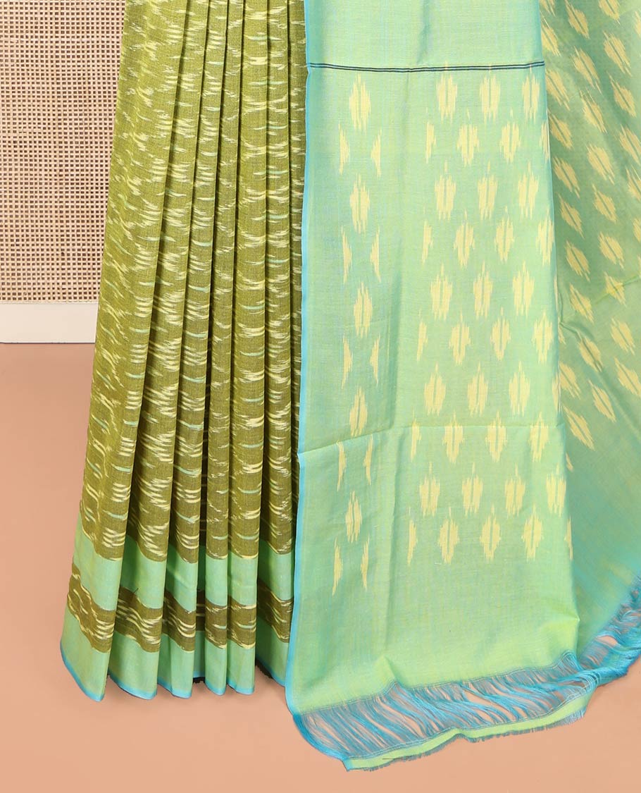 Light Green Ikkat Cotton Saree, Accentuated with Ikkat-Style Ogee Patterns on Its Body, Complemented by a Contrast Ikkat Textured Border, Pallu Steeped with Ikkat-Style Buttas, and Has No Blouse