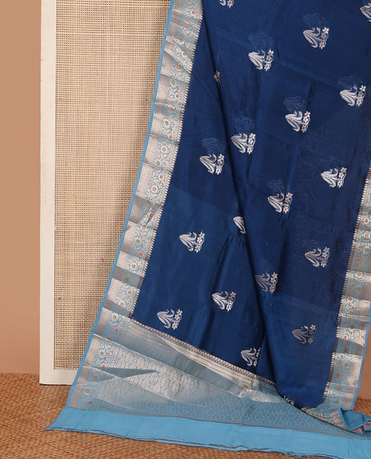 Blue floral buttas raw mango silk saree, contrast traditional zari design border, and intricate pallu