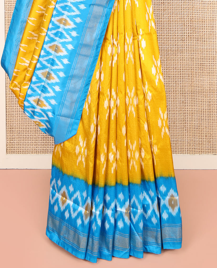 Mustard Ikkat Silk Saree, Masterfully Woven with Ikkat Buttas All Over Its Body, Complemented by a Contrast Diamond-Patterned Border, Pallu of Ikkat Butta Enclosed Checks, and Paired with a Contrast Blouse