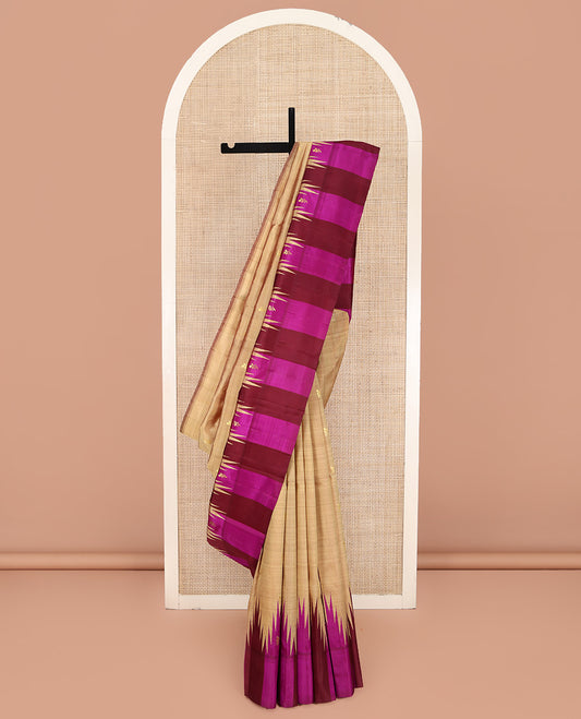 Sandal Kanchipuram Silk Saree, Elevated with Zari Buttas on Its Body, Complemented by a Contrast One-Sided Thazampoo Rekku Border of Zari Buttas, Pallu Steeped with Zari Designs, and Comes Without a Blouse