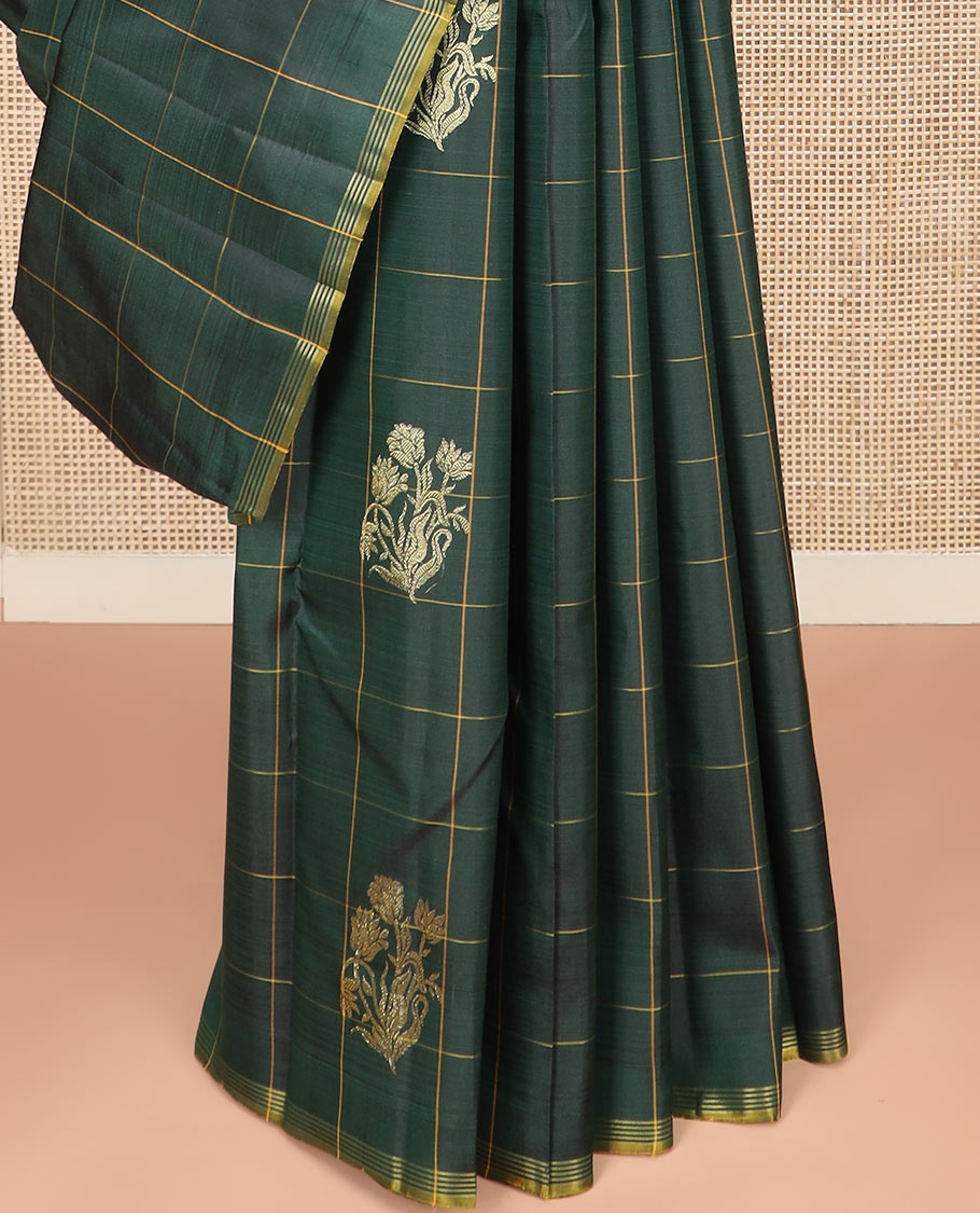 Green Kanchipuram Silk Saree Featuring Floral Zari Buttas Enclosed in Checks, Complemented by a Contrast Striped Border, a Regal Pallu Woven with Intricate Zari Designs, Paired with a Matching Blouse