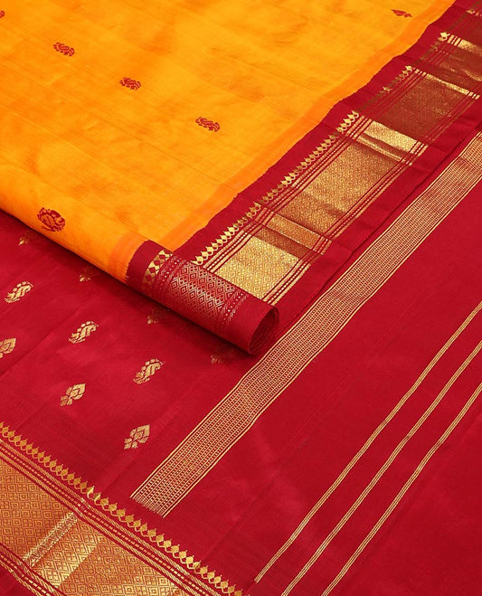 Orange buttas kancheepuram silk saree with contrast korvai border of thilakam mokku, muthu, banaras design & zari design pallu
