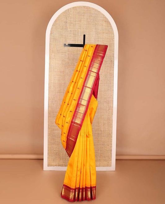 Orange buttas kancheepuram silk saree with contrast korvai border of thilakam mokku, muthu, banaras design & zari design pallu