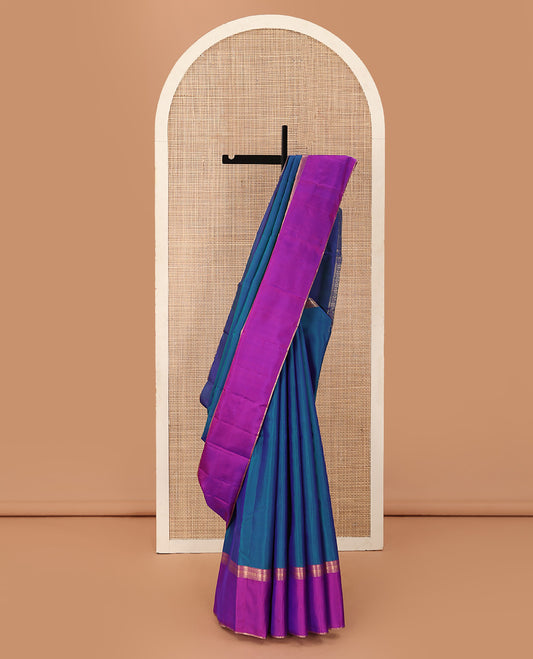 Blue plain Kanchipuram silk saree, contrast ganga jamuna rettai pettu border of rekku, neli, banaras, and rudraksham designs, and pallu of kathir, rudraksham, neli, poun, ara bogudi, and ara maadam