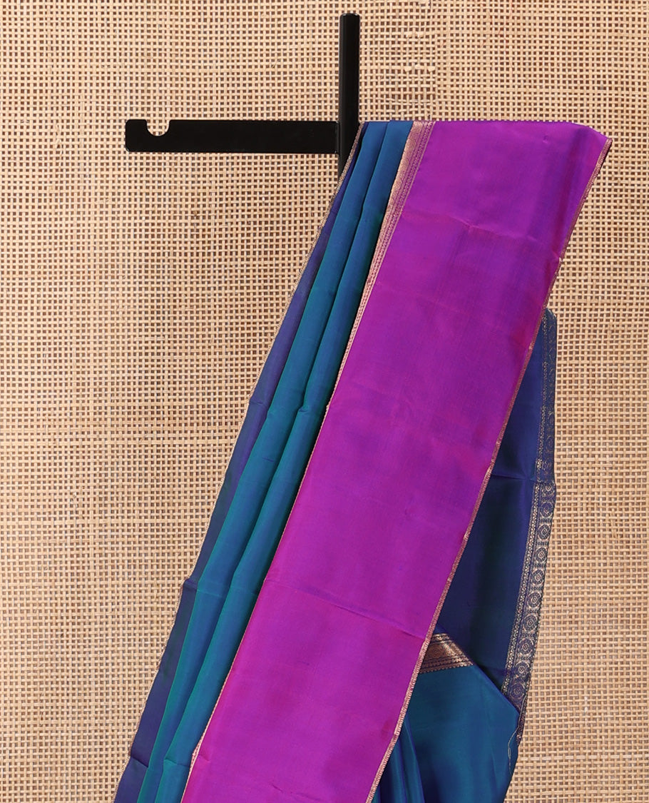 Blue plain Kanchipuram silk saree, contrast ganga jamuna rettai pettu border of rekku, neli, banaras, and rudraksham designs, and pallu of kathir, rudraksham, neli, poun, ara bogudi, and ara maadam