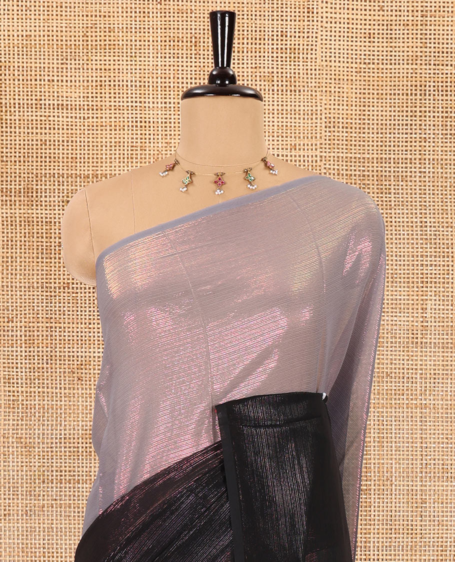 Borderless black ombre-toned gleaming Shimmer Georgette saree, self-pallu with tassels and a plain brown blouse