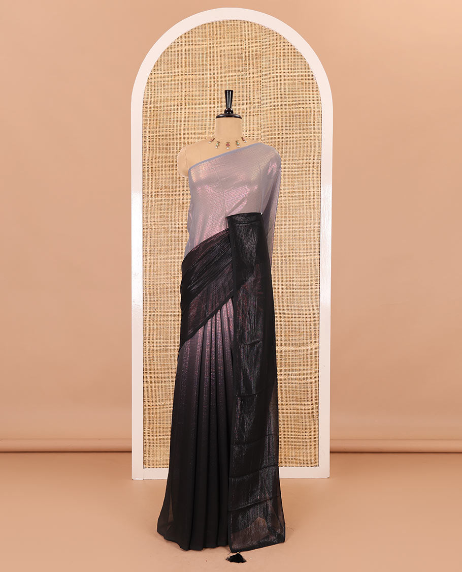Borderless black ombre-toned gleaming Shimmer Georgette saree, self-pallu with tassels and a plain brown blouse