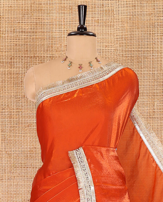 Orange plain design fendy satin saree, contrast lace border, and a matching blouse