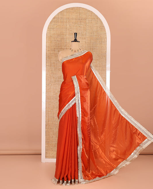 Orange plain design fendy satin saree, contrast lace border, and a matching blouse