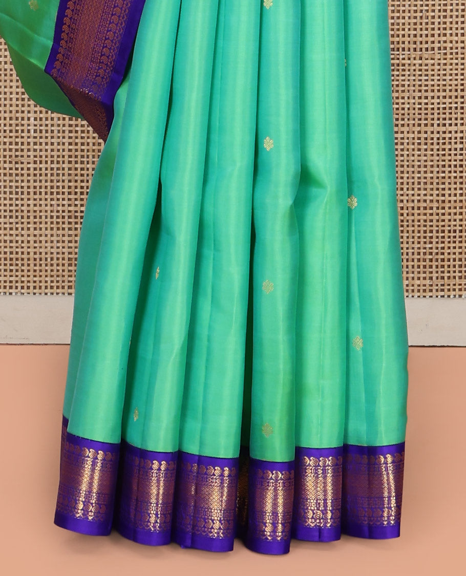 Greenish Turquoise Vasundhara Silk Saree, Showcasing Zari Buttas All Over Its Body, Complemented by a Contrast Border of Manga, Diamond, and Mayil Kann Designs, Grand Jaal Pallu, and Paired with a Contrast Blouse