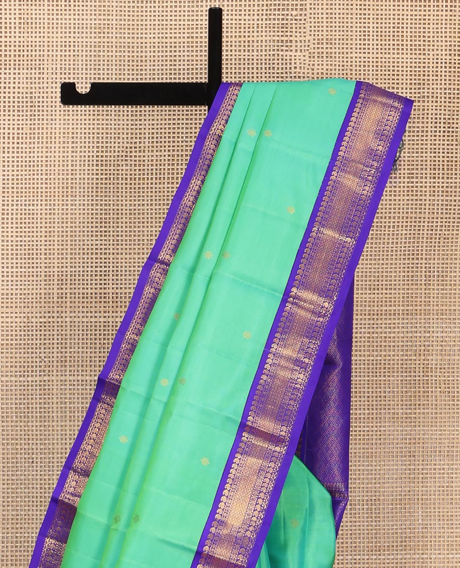 Greenish Turquoise Vasundhara Silk Saree, Showcasing Zari Buttas All Over Its Body, Complemented by a Contrast Border of Manga, Diamond, and Mayil Kann Designs, Grand Jaal Pallu, and Paired with a Contrast Blouse