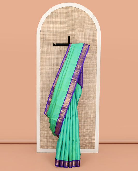 Greenish Turquoise Vasundhara Silk Saree, Showcasing Zari Buttas All Over Its Body, Complemented by a Contrast Border of Manga, Diamond, and Mayil Kann Designs, Grand Jaal Pallu, and Paired with a Contrast Blouse