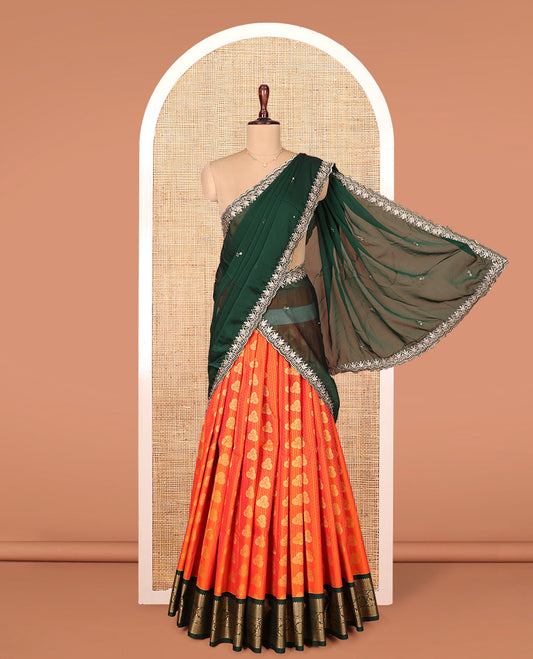 Orange Art Silk Material Half Saree Set, Elevated with Zari Buttas on Its Skirt, Complemented by Contrast Traditional Zari Design Border, Paired with a Contrast Blouse, and a Scallop Embroidered Dhavani