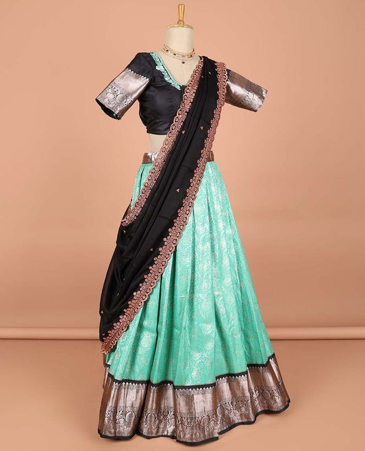 Green floral jacquard semi-stitched half saree with contrast zari border,  embroidered blouse & scallop border dhavani