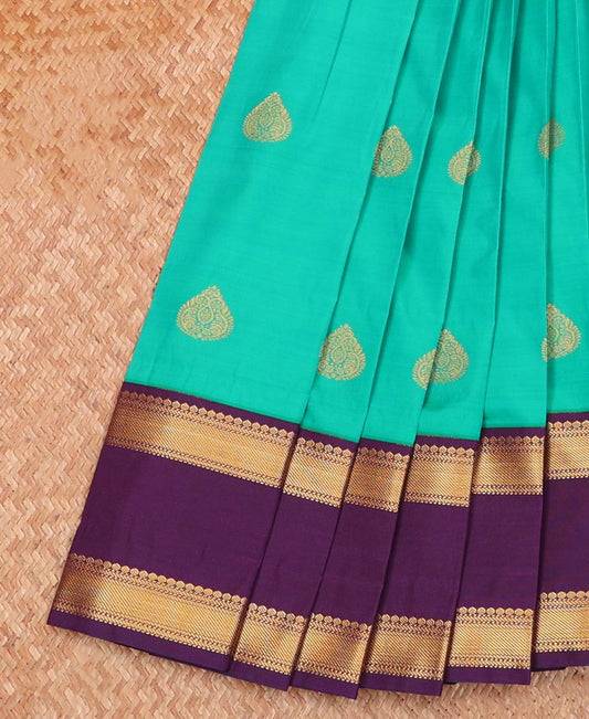 Green Budget Silk Saree Ornamented with Zari Buttas, Highlighted with Contrast Traditional Zari Design Woven Rettai Pettu Border, Zari Elevated Jaal Pallu, and a Paired with a Contrast Blouse
