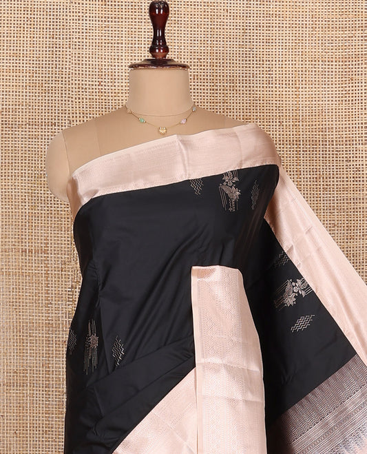 Black Budget Silk Saree, Gleamed Up with Zari Buttas All Over Its Body, Complemented by Contrast Border of Traditional Designs Woven in Zari, Grandly Bedecked Pallu, and Paired with a Contrast Blouse