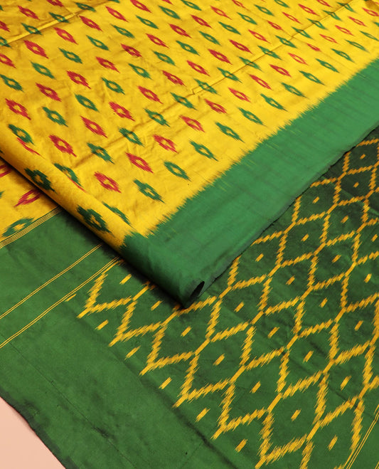 Yellow Ikkat Silk Saree Ornamented with Ikkat Buttas, Featuring a Contrast Plain Border, Complemented by a Pallu Ikkat Woven in an Ogee Pattern