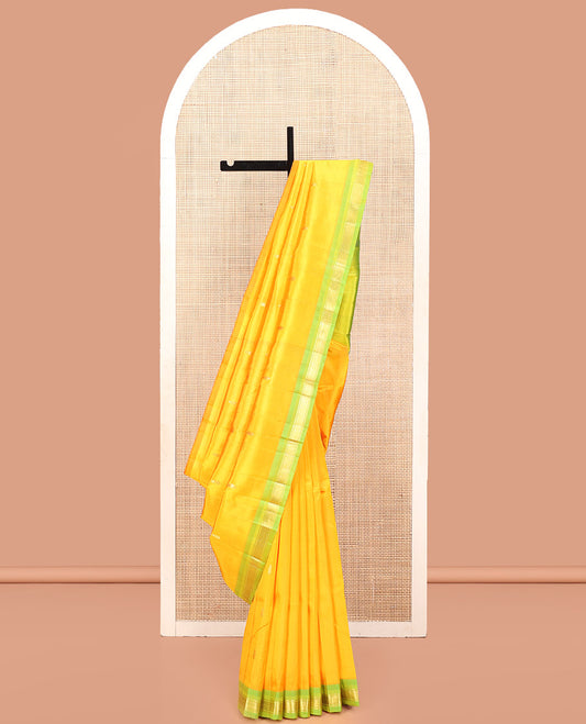 Yellow Kanchipuram Silk Saree, Subtly Sparkled with Zari Buttas, a Contrast One-Sided Border of Banaras, and Mayil Kann Design, Zari-Woven Pallu, and No Blouse