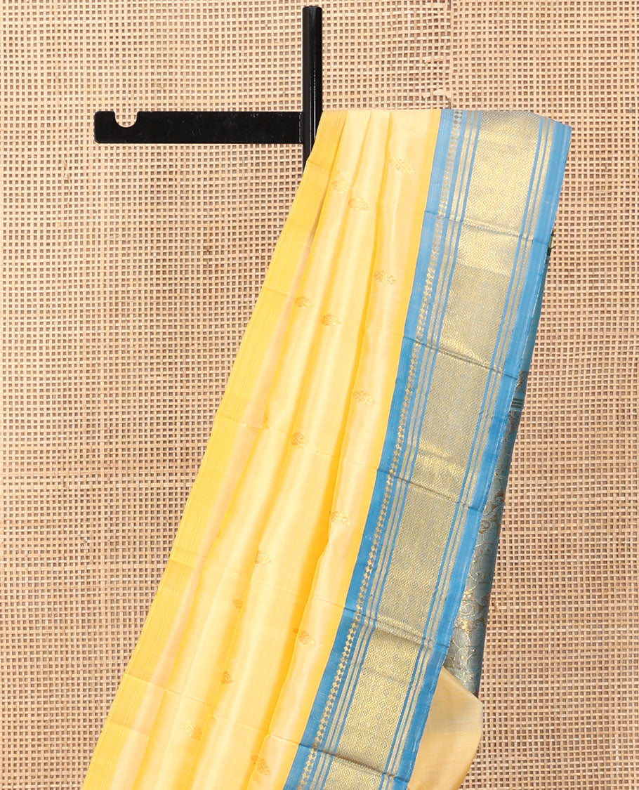 Pale Yellow Kanchipuram Silk Saree, Sparsely Woven with Zari Buttas, a Contrast One-Sided Border of Panner Sombu, Banaras, and Jaal Designs, a Zari Design Pallu, and No Blouse