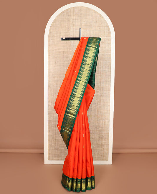 Orange zari buttas Kanchipuram silk saree, contrast one-sided korvai border of paneer sombu, banaras, muthu, and mayil kann, and zari design pallu