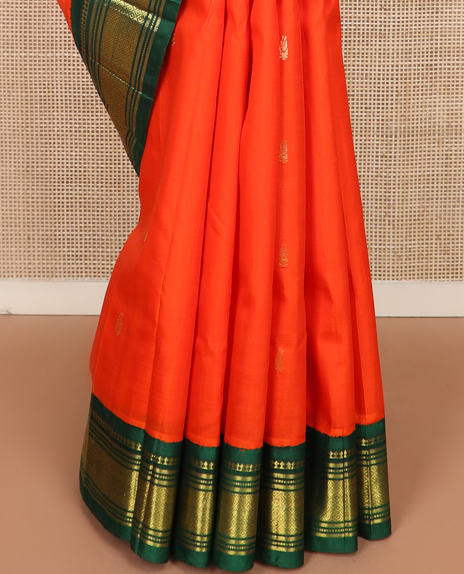 Orange zari buttas Kanchipuram silk saree, contrast one-sided korvai border of paneer sombu, banaras, muthu, and mayil kann, and zari design pallu