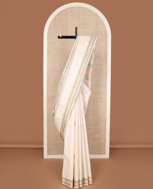 Cream malli mokku Kanchipuram silk saree, self-border of thilakam mokku, rudraksham, and mayil kann, and pallu of thilakam mokku, chakram, seppu rekku, and geometric patterns