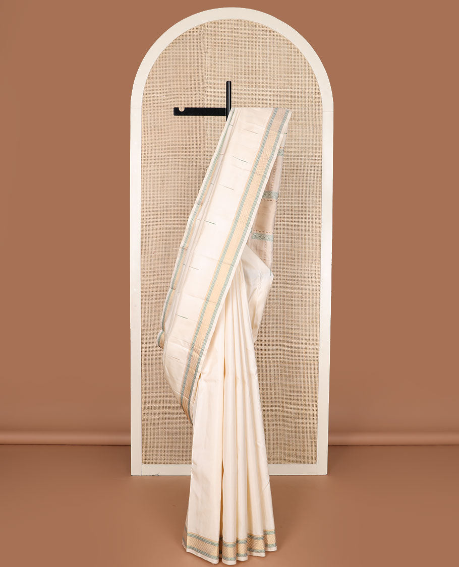 Cream malli mokku Kanchipuram silk saree, self-border of thilakam mokku, rudraksham, and mayil kann, and pallu of thilakam mokku, chakram, seppu rekku, and geometric patterns