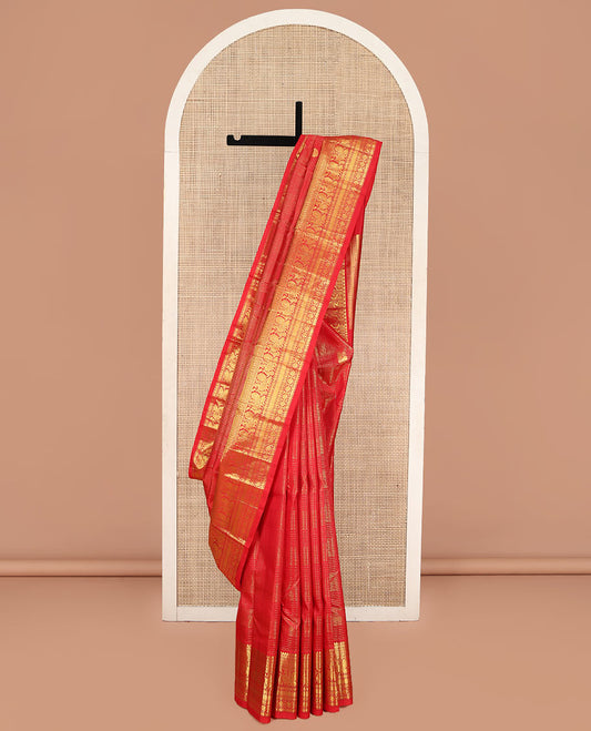 Red Kanchipuram Silk Saree, Gleamed Up with Mayil Butta Enclosed Checks, Highlighted by One-Sided Border of Thilakam Mokku, Kamalam, Mayil, Chakram, and Rudraksham Designs, Pallu of Chakram and Mayil Designs, and Comes Without a Blouse