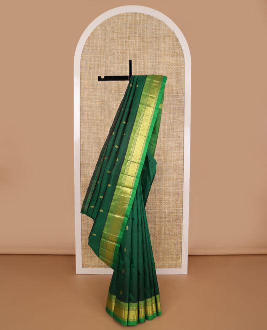 Dark green buttas kancheepuram silk saree with contrast border of thilakam mooku, banaras, muthu design & zari design pallu