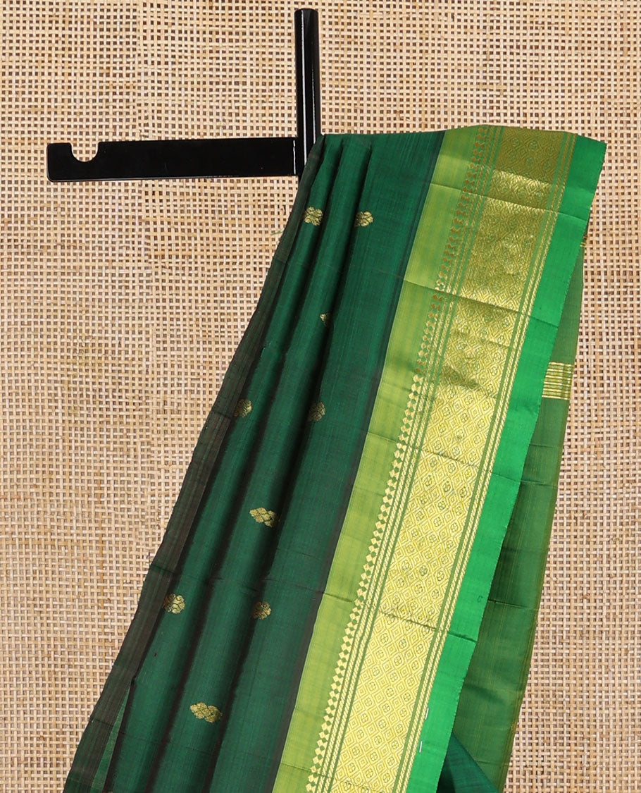 Dark green buttas kancheepuram silk saree with contrast border of thilakam mooku, banaras, muthu design & zari design pallu