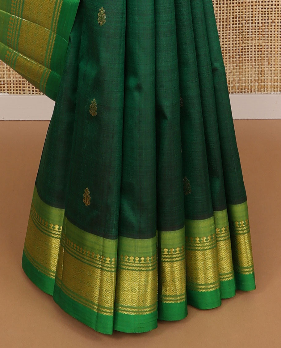 Dark green buttas kancheepuram silk saree with contrast border of thilakam mooku, banaras, muthu design & zari design pallu