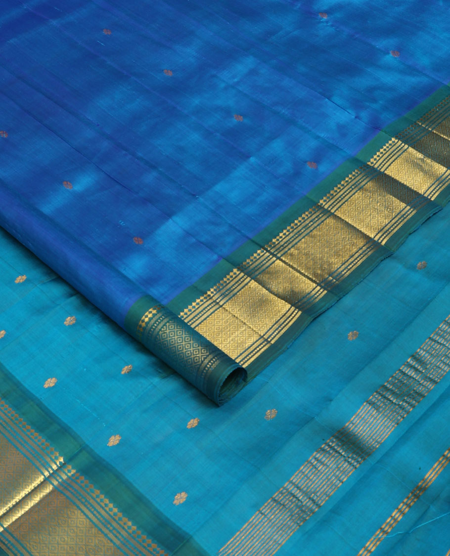 Blue Kanchipuram silk saree with zari buttas, contrast one-sided border of panner sombu,banaras,muthu & mayil kann & zari design pallu