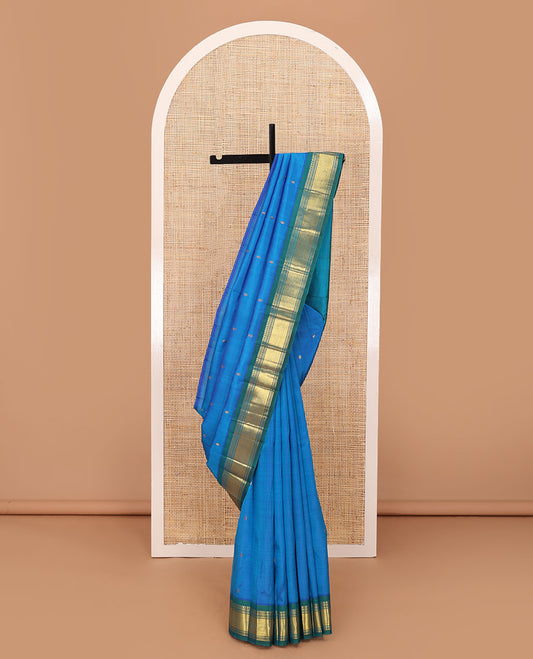 Blue Kanchipuram silk saree with zari buttas, contrast one-sided border of panner sombu,banaras,muthu & mayil kann & zari design pallu