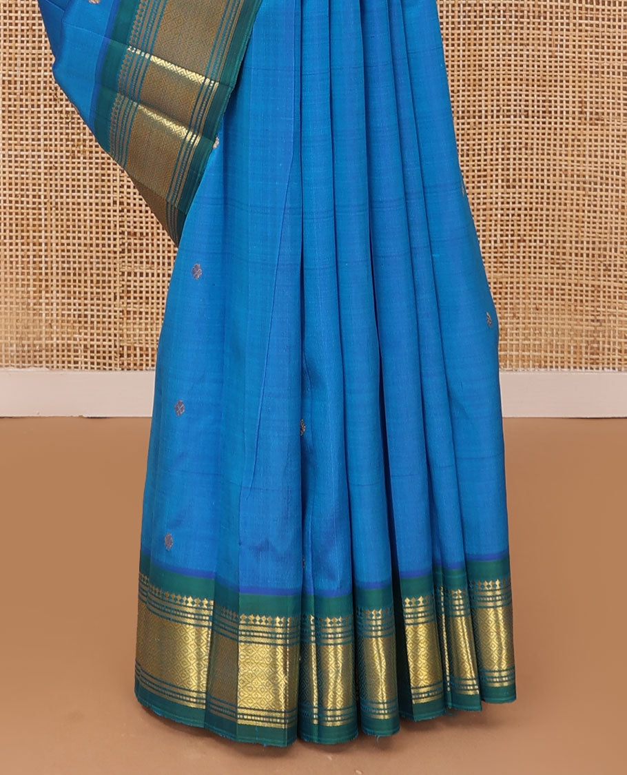 Blue Kanchipuram silk saree with zari buttas, contrast one-sided border of panner sombu,banaras,muthu & mayil kann & zari design pallu