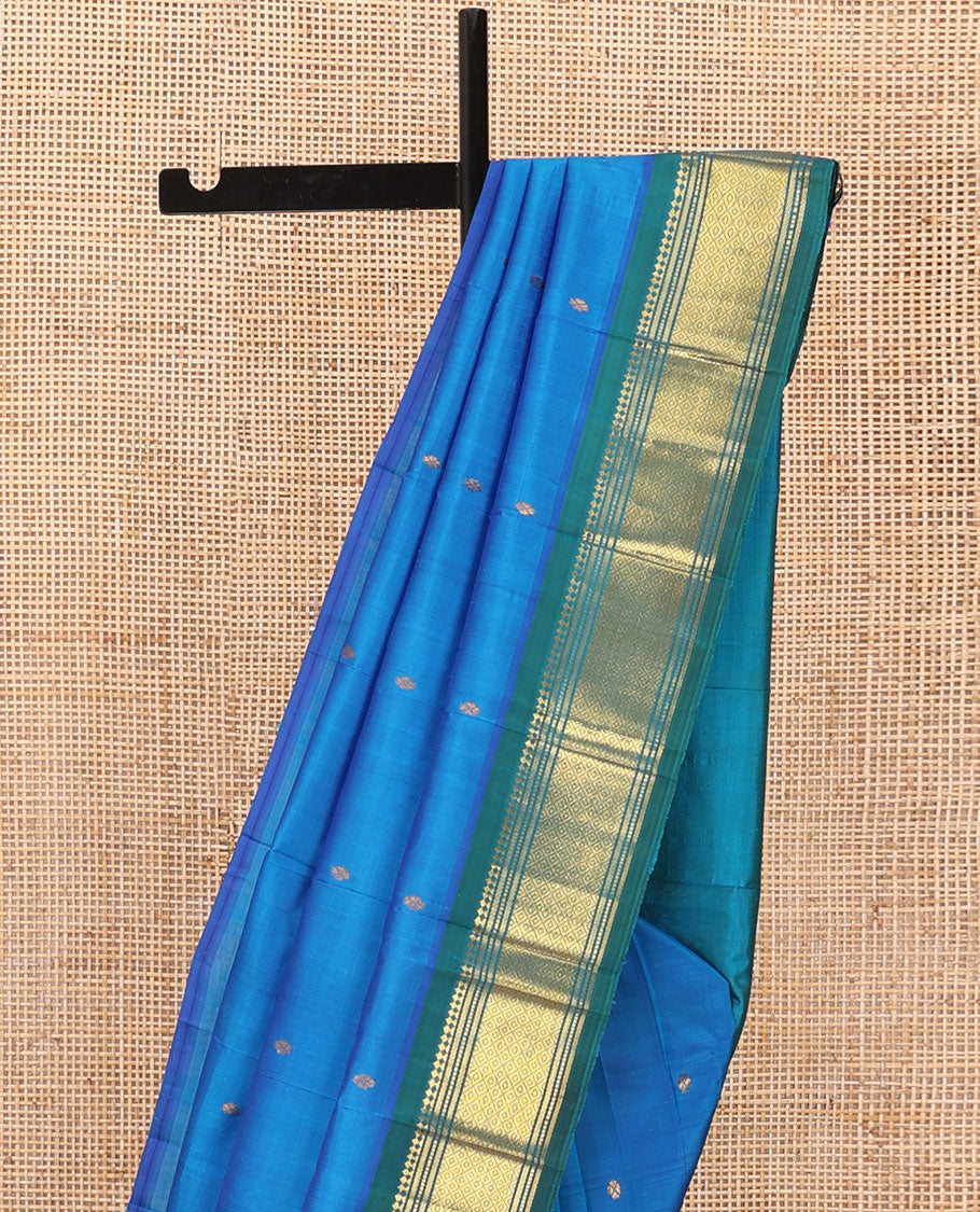 Blue Kanchipuram silk saree with zari buttas, contrast one-sided border of panner sombu,banaras,muthu & mayil kann & zari design pallu