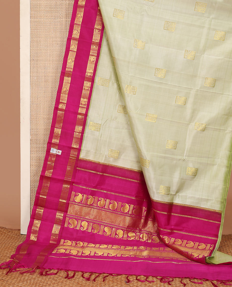 Pale green zari buttas Kanchipuram silk saree, contrast one-sided korvai rettai pettu border of rekku,mayil, manga, and diamond, and pallu of manga, and vanki