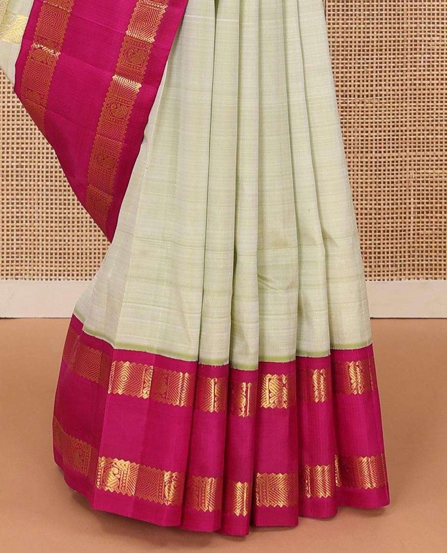Pale green zari buttas Kanchipuram silk saree, contrast one-sided korvai rettai pettu border of rekku,mayil, manga, and diamond, and pallu of manga, and vanki