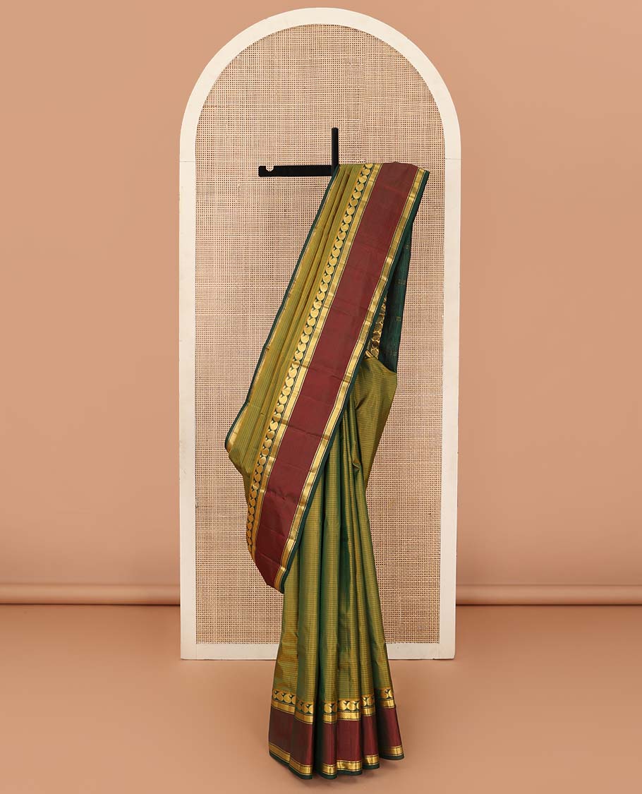 Green striped Kanchipuram silk saree, contrast rettai pettu border of manga, neli, and diamond designs, and striped pallu