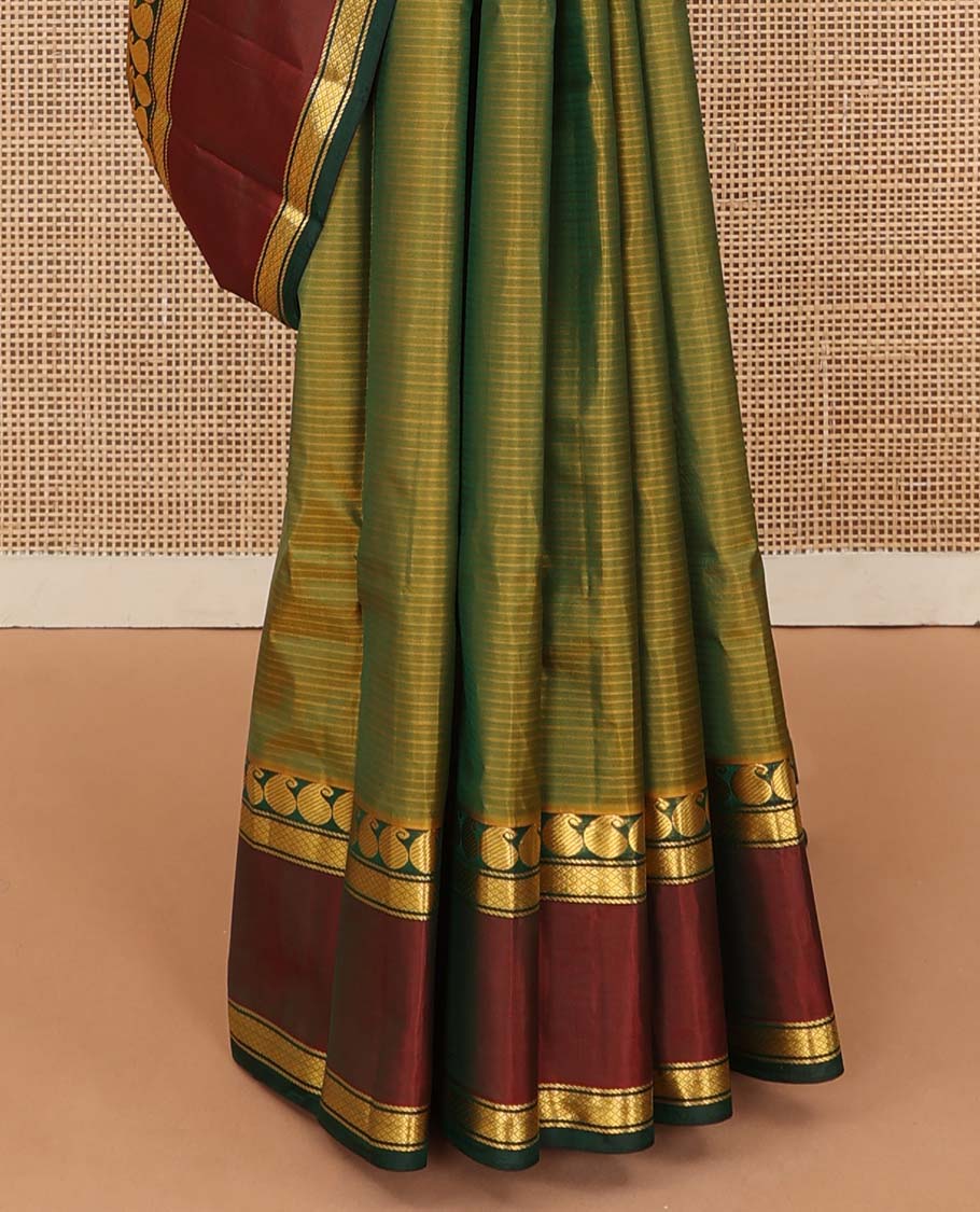 Green striped Kanchipuram silk saree, contrast rettai pettu border of manga, neli, and diamond designs, and striped pallu