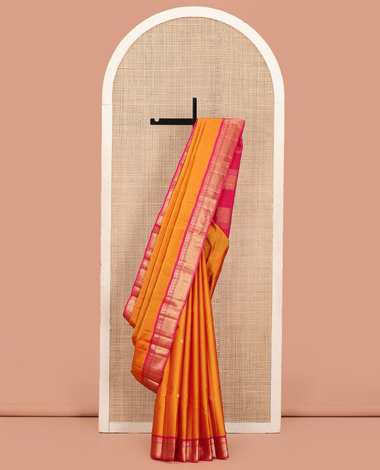 Orange Kanchipuram Silk Saree Decked Up with Zari Buttas, Complemented by Contrasting Border of Rekku, Banaras, Mayil, and Mayil Kann Designs, Pallu Mirroring the Same Border Design, and Paired with a Contrast Blouse