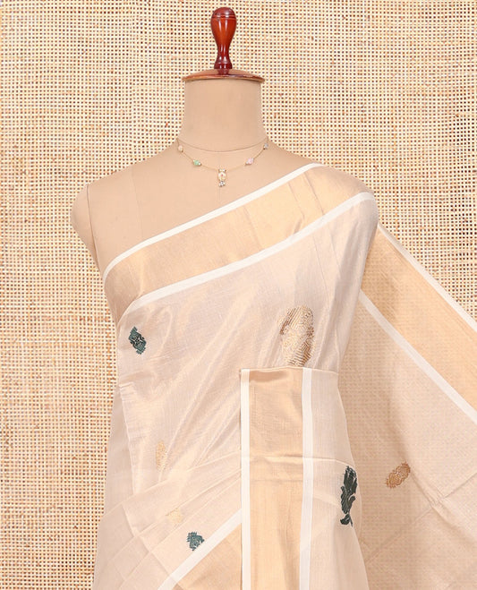 Cream Kerala Cotton Saree, Decorated with Zari Buttas All Over Its Body, a Zari Bavanji Border, Pallu of Intricate Designs, and Paired with a Matching Blouse