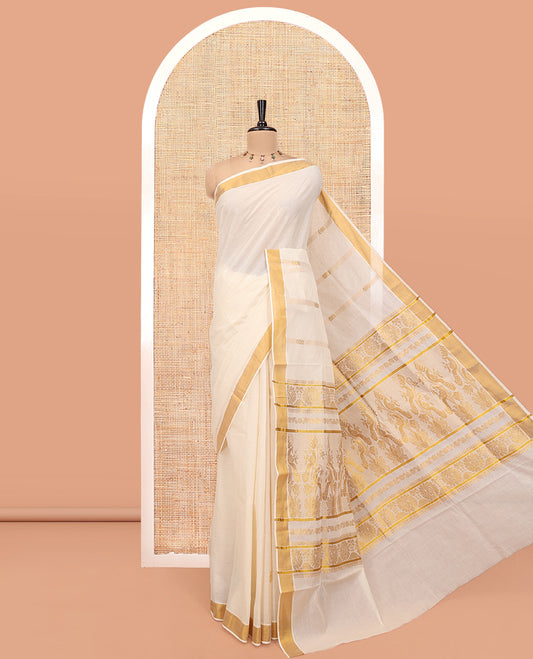 Cream Kerala Cotton Saree, Delicately Woven with Zari Stripes All Over Its Body, a Subtle Bavanji Border, Pallu Depicts Peacock Designs, and Paired with a Matching Blouse