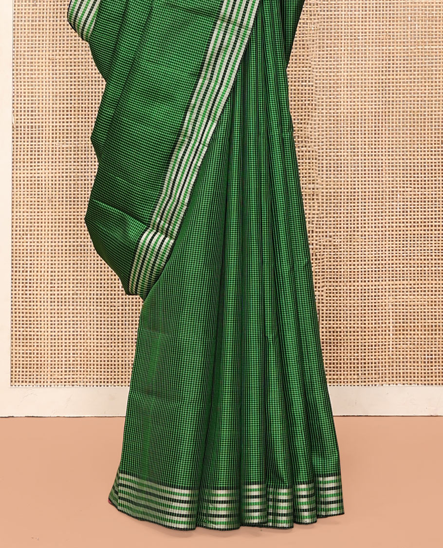 Green and Black Mayuri Soft Silk Saree, Subtly Sparkled with Kasa-Kasa Checks All Over Its Body, Highlighted by Zari Striped Border, Delicately Woven Pallu of Ikkat Texture, and Paired with a Contrast Blouse