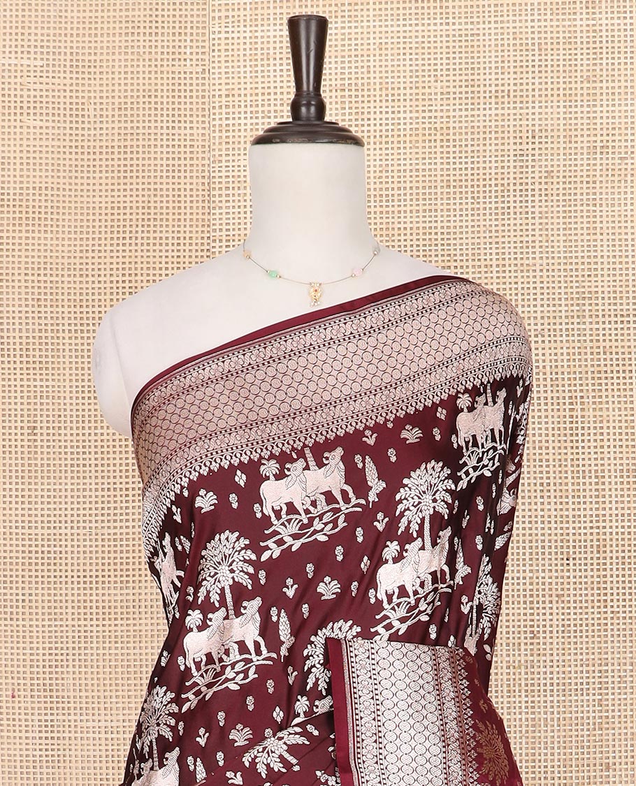 Maroon zari buttas and Pichwai cow buttas mushru silk saree, traditional design border, and zari-rich jaal pallu