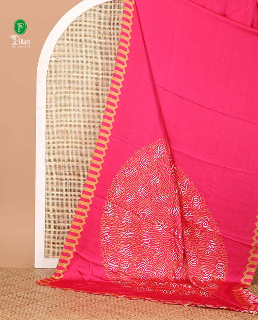 Rani pink plain gajji silk saree features a temple-printed border, a circular-shaped vine-patterned pallu, and a unique motif-printed blouse
