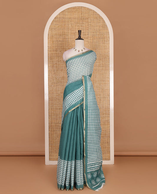 Green plain and polka dots printed linen cotton saree with piping zari border, floral-geometric print pallu, and contrast flower buttas printed  blouse