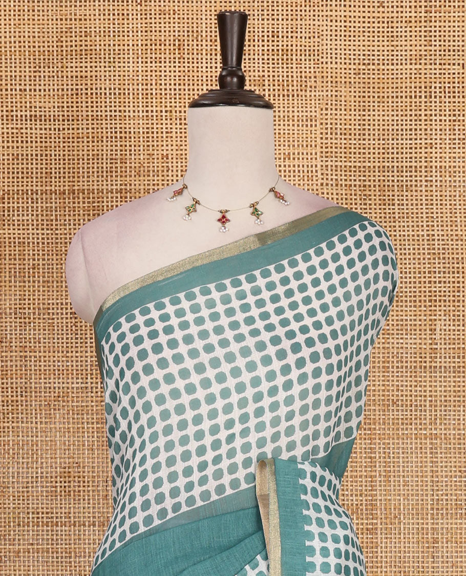 Green plain and polka dots printed linen cotton saree with piping zari border, floral-geometric print pallu, and contrast flower buttas printed  blouse