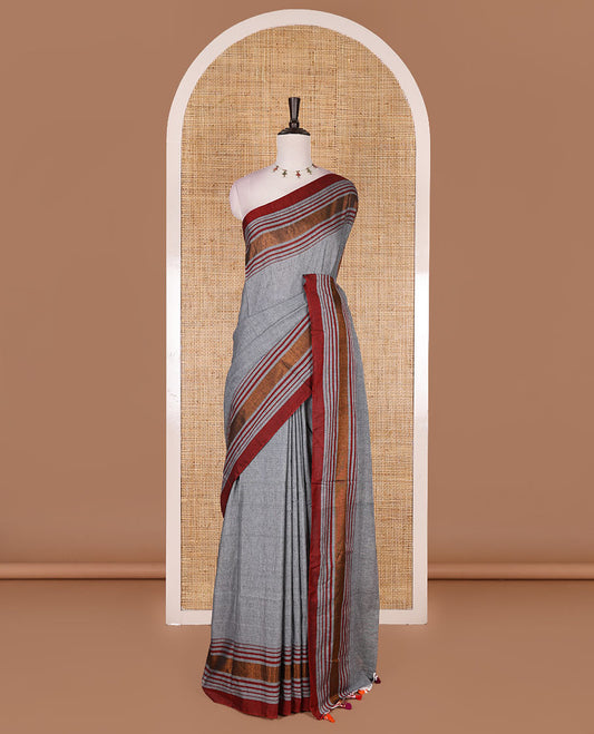 Grey-red plain design mul mul cotton saree, contrast copper zari horizontally striped border, plain pallu, and plain blouse